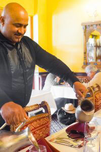 Taj Of Marin - Updated Hours - Man pouring water on glasses